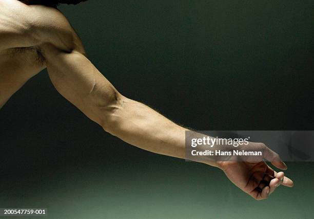 man extending arm, close-up on arm - arm lichaamsdeel stockfoto's en -beelden