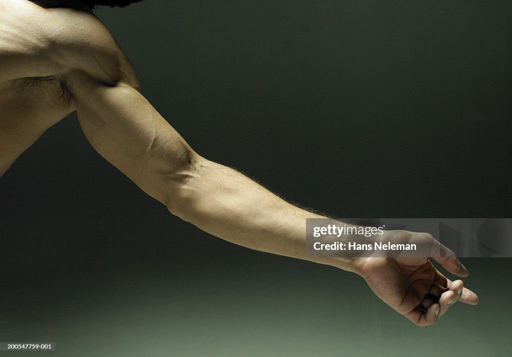 Man extending arm, close-up on arm