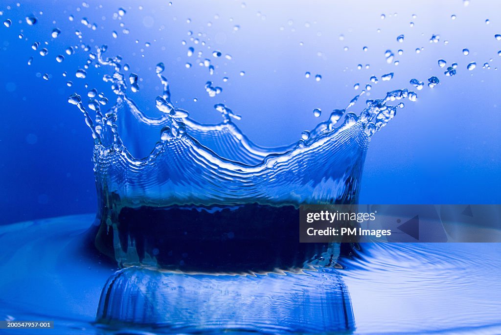 Splash in water creating crown of water droplets, close-up