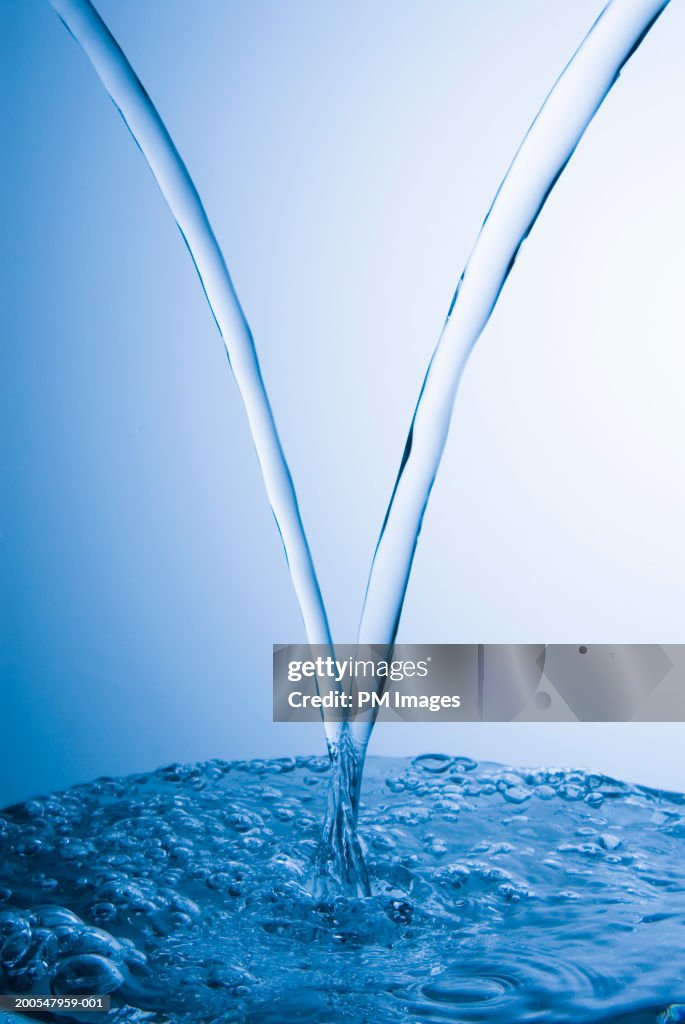 Two Streams Image Two Streams Of Water Mixing Together Against Blue Background High-Res ...