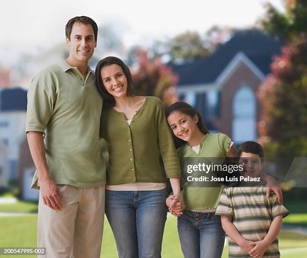 family with children (4-9) standing in row in garden - fou stock pictures, royalty-free photos & images