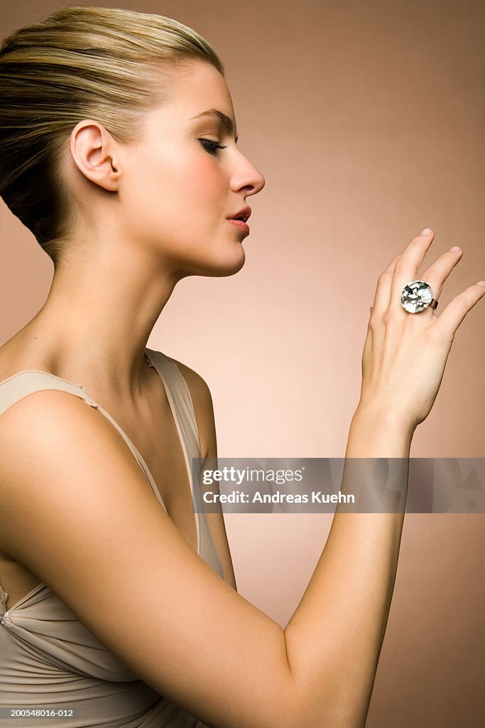 Young woman looking at diamond ring, close-up