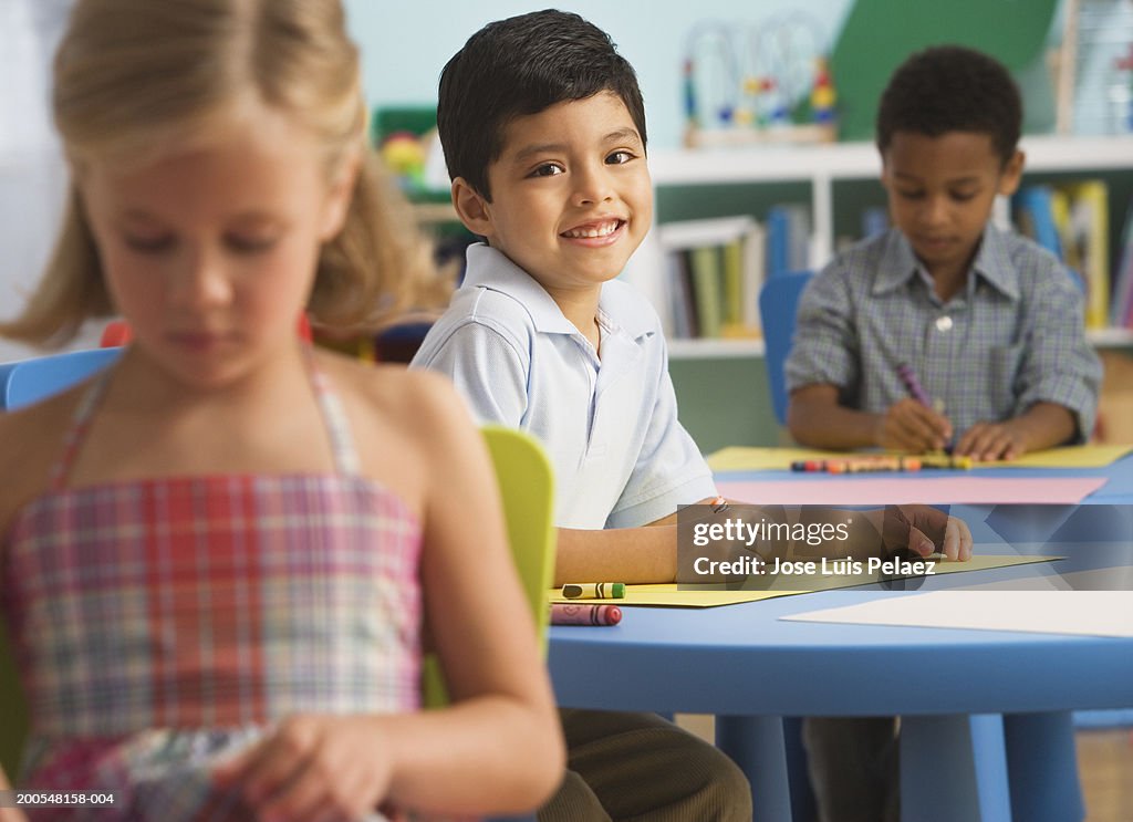 Children (2-7) sitting in the classroom