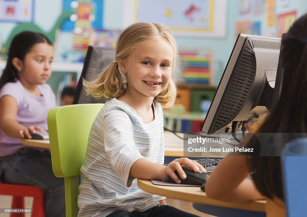 Girls (4-7) using computer, portrait