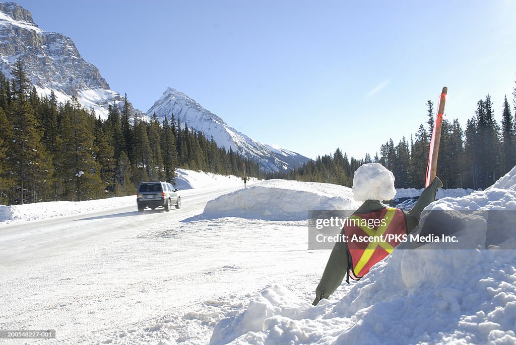 Snowman dressed in traffic control vest