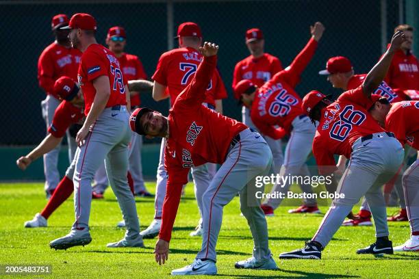 Fort Myers, FL Players stretch on the first day of Spring Training.