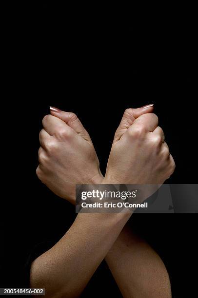 human arms crossed, making fist, close-up, (digital composite) - gesturing stock pictures, royalty-free photos & images
