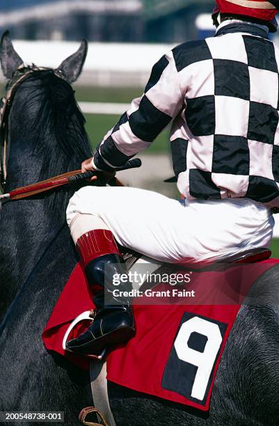 jockey on racehorse, side view, close-up - jockey stock pictures, royalty-free photos & images