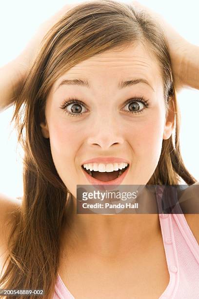 young woman with hands on head, smiling, close-up, portrait - eyes open stock pictures, royalty-free photos & images