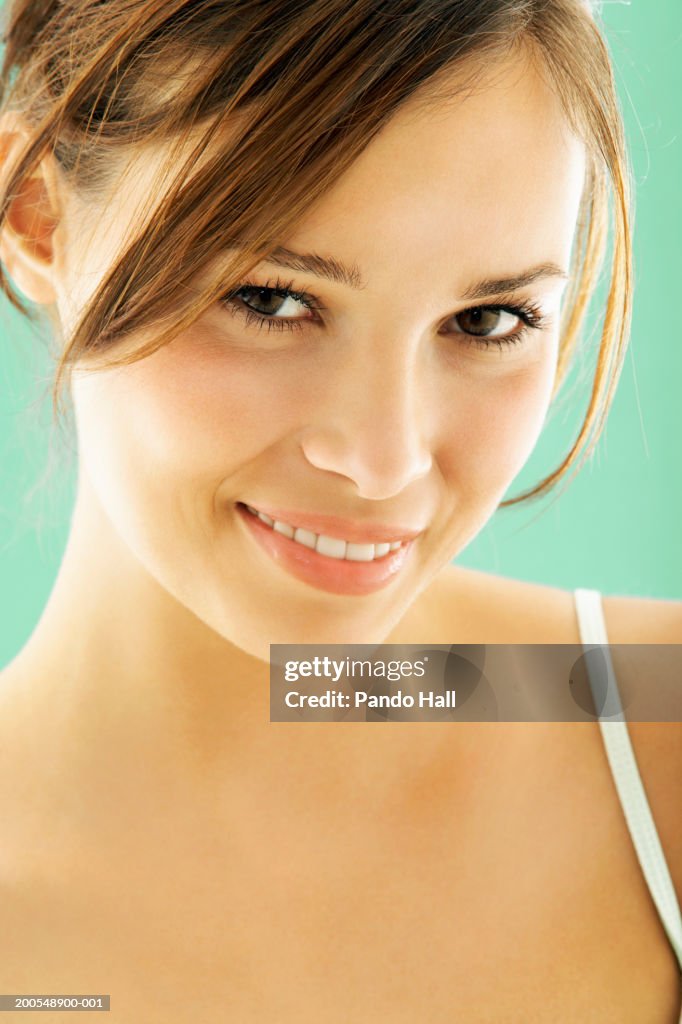 Young woman smiling, close-up, portrait