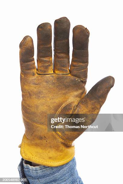 man wearing leather work glove, close-up of hand - guanto di pelle foto e immagini stock