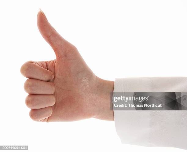 female doctor giving thumbs up sign, close-up of hand - sleeve stock pictures, royalty-free photos & images