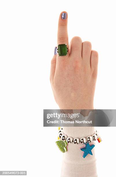 teenage girl (14-16) pointing up, close-up of hand - chicas pulseras fotografías e imágenes de stock