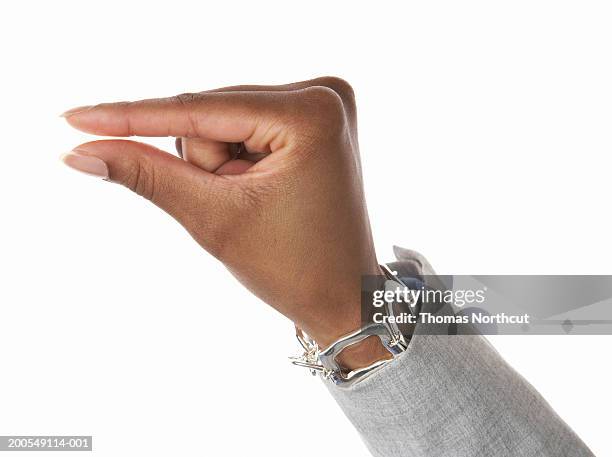 young woman making pinching gesture, close-up of hand - pressure photos et images de collection