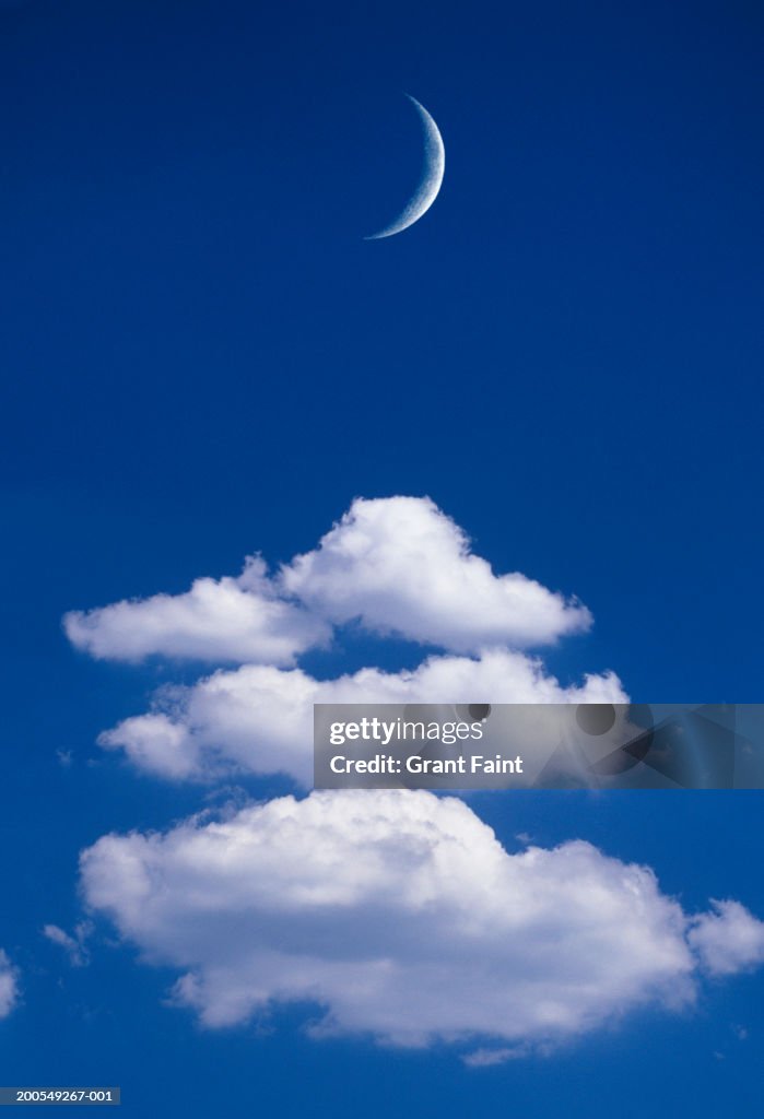 Moonrise over clouds in blue sky