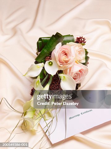 Bridal bouquet and marriage certificate on fabric, close-up Bridal bouquet and marriage certificate on fabric, close-up