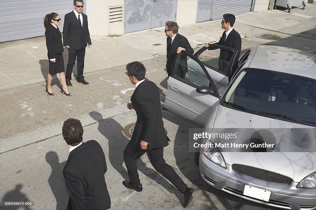 Business people meeting up on sidewalk