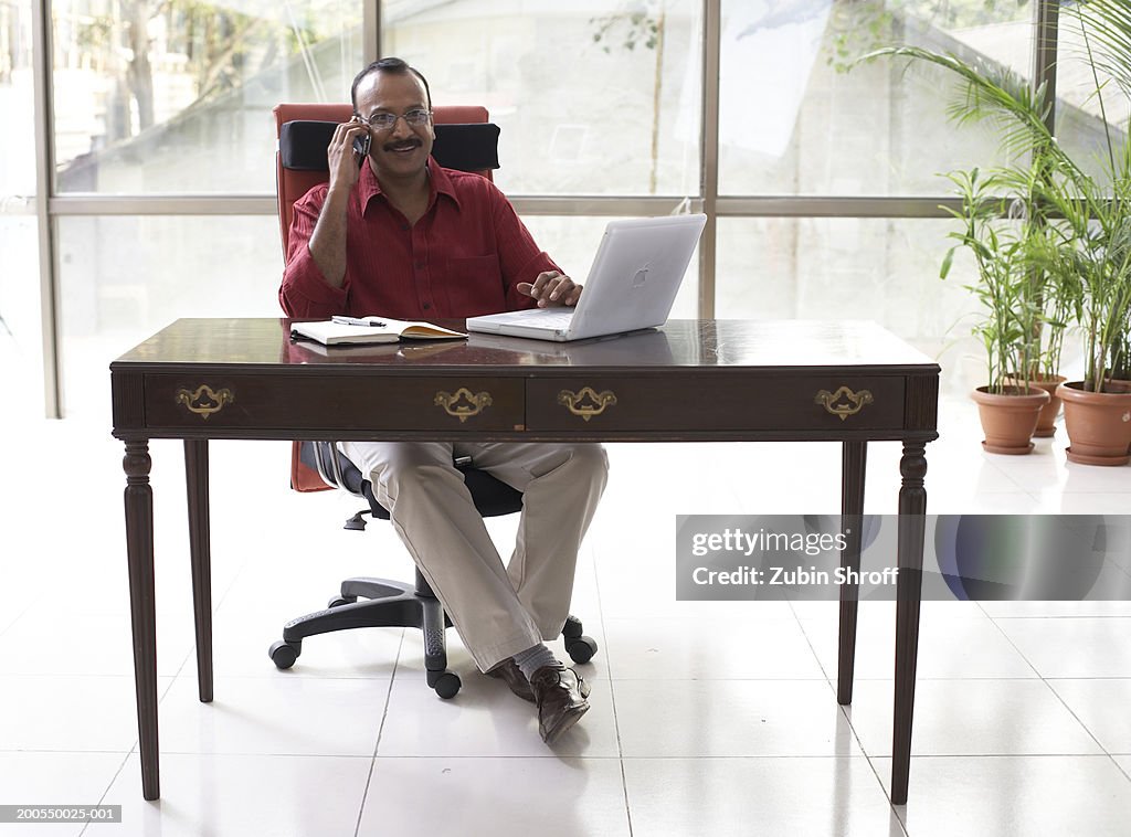 Mature businessman using mobile phone