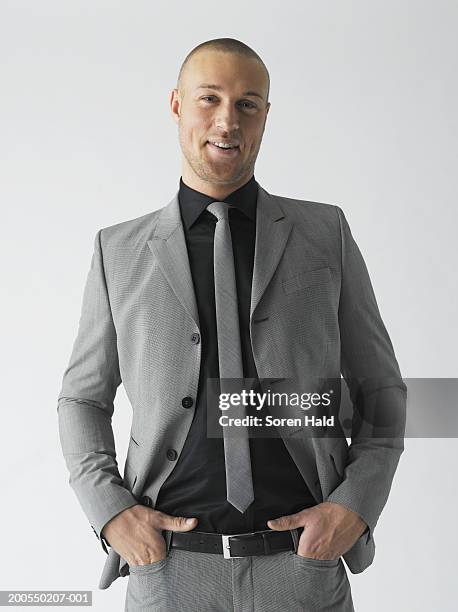 young businessman in grey suit, smiling, portrait - gray suit stock-fotos und bilder
