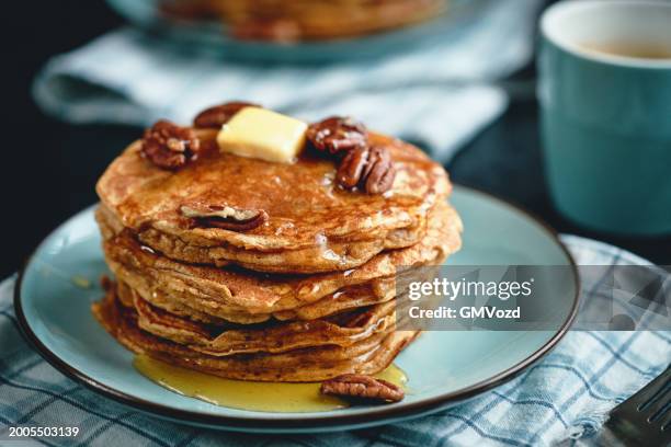 stack of sweet potato pancakes with butter and pecan nuts - sweet potato pancakes stock pictures, royalty-free photos & images