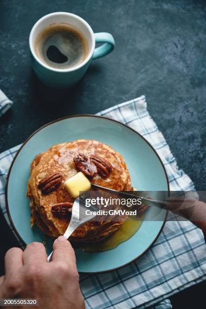 stack of sweet potato pancakes with butter and pecan nuts - sweet potato pancakes stock pictures, royalty-free photos & images