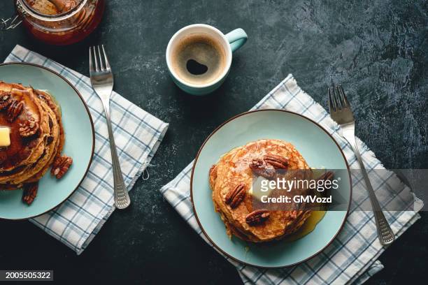 stack of sweet potato pancakes with butter and pecan nuts - sweet potato pancakes stock pictures, royalty-free photos & images