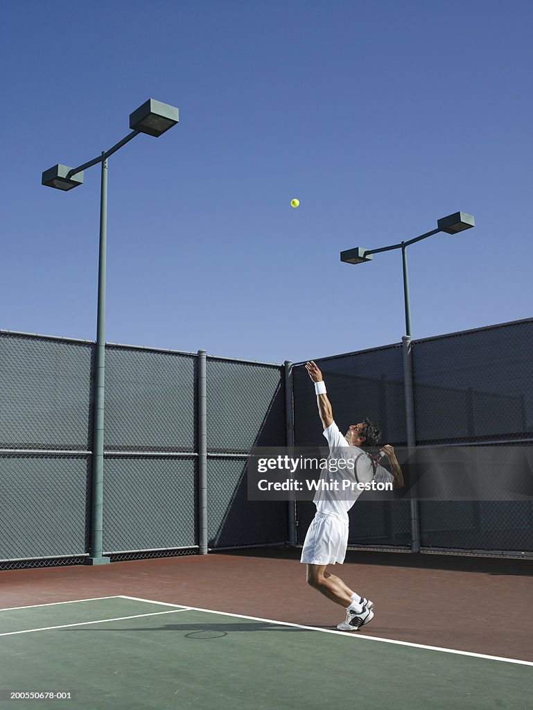 Man serving during tennis match