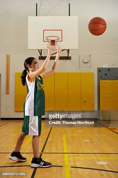 girl (7-9) playing basketball, side view - throwing stock pictures, royalty-free photos & images