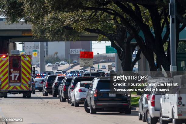 Emergency vehicles line the feeder road outside Lakewood Church during a reported active shooter event Sunday, Feb. 11, 2024 in Houston.