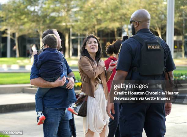 People ask a Houston Police officer for directions outside of Lakewood Church on Sunday, Feb. 11 in Houston, after a reported shooting during a...