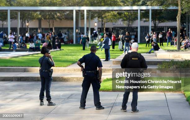 Houston Police officers watch over displaced church goers outside Lakewood Church on Sunday, Feb. 11 in Houston, after a reported shooting during a...