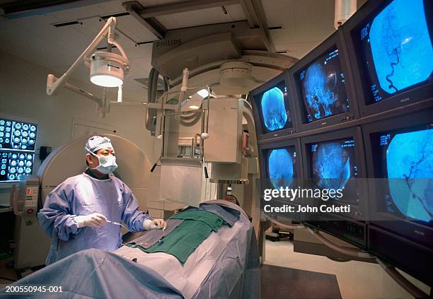 doctor performing brain surgery on patient - surgical equipment stock pictures, royalty-free photos & images