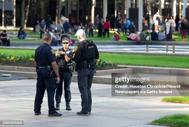 Houston Police officers watch over displaced church goers outside Lakewood Church on Sunday, Feb. 11 in Houston, after a reported shooting during a...