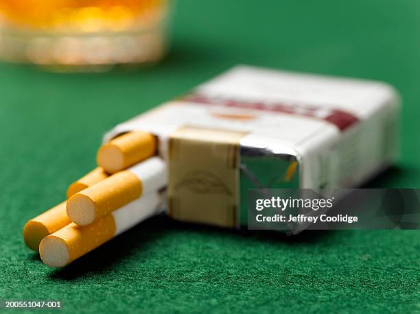 cigarette pack open on table, close-up - paquete de cigarrillos fotografías e imágenes de stock