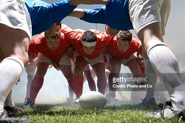young rugby players forming scrum in field - melé fotografías e imágenes de stock