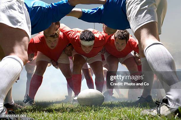 young rugby players forming scrum in field - playing rugby stock pictures, royalty-free photos & images