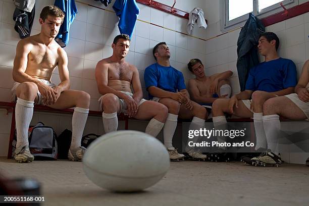rugby players sitting in changing room, ball in foreground - rugby players in changing room 個照片及圖片檔