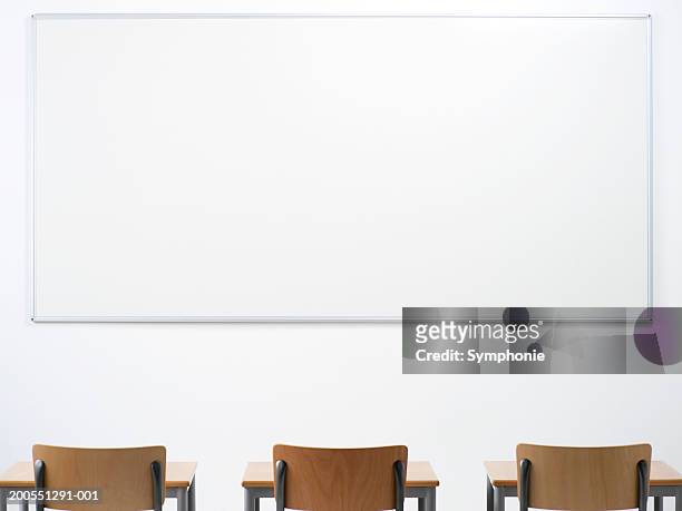 desk and chair in classroom - smart board stock-fotos und bilder