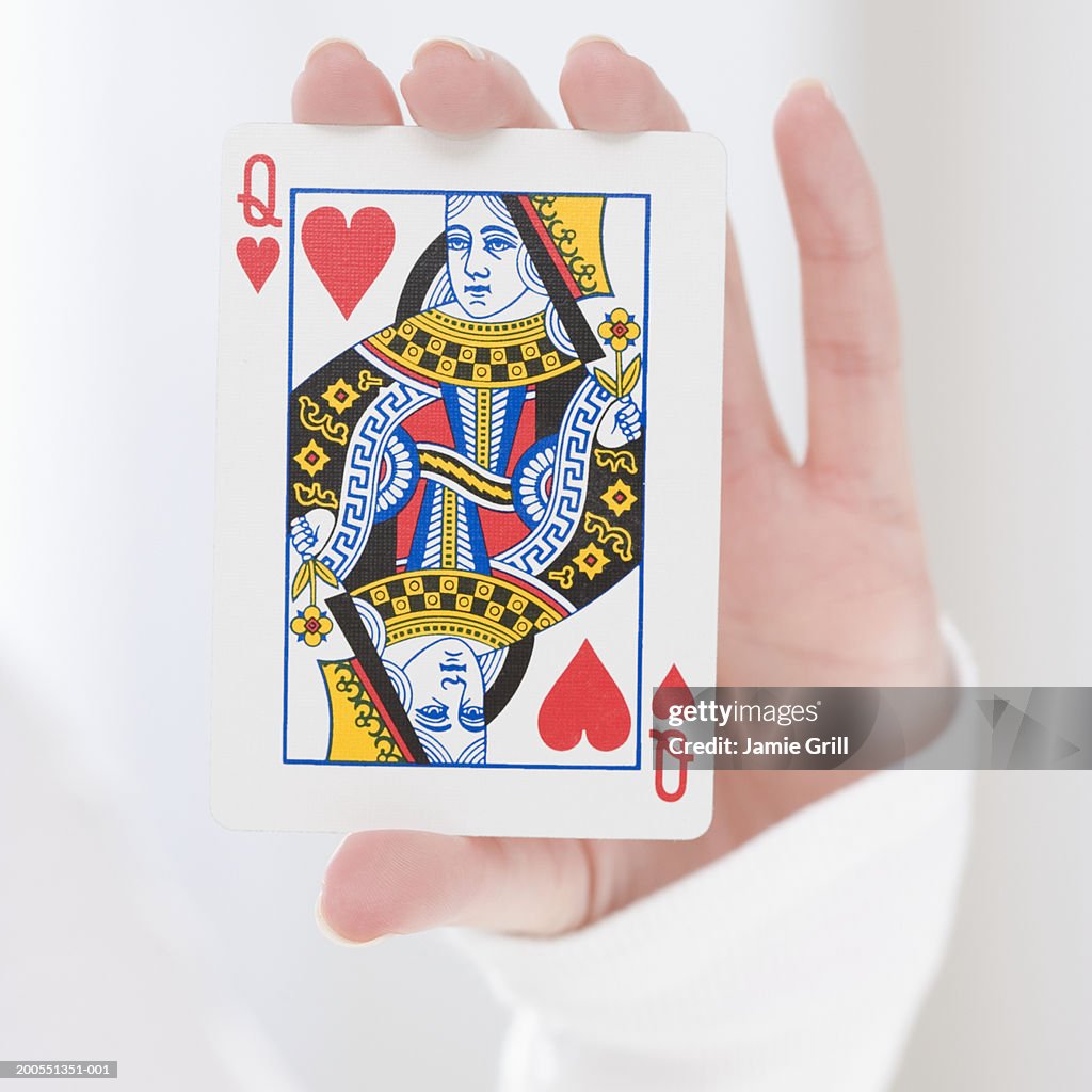 Woman holding queen card, close-up