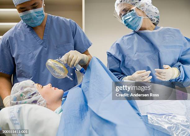 surgeon applying gas mask to patient - anesthetist stock pictures, royalty-free photos & images