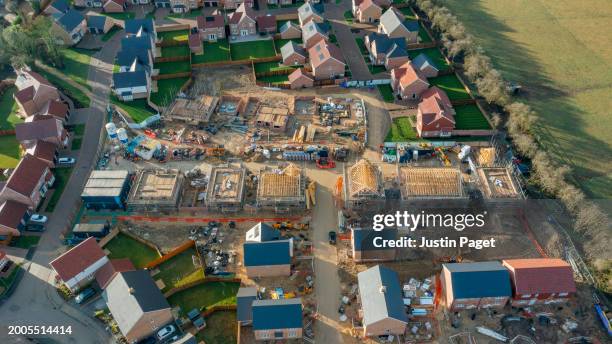 drone view of a residential development in a village in cambridgeshire, uk. some of the houses are under construction - new stock pictures, royalty-free photos & images