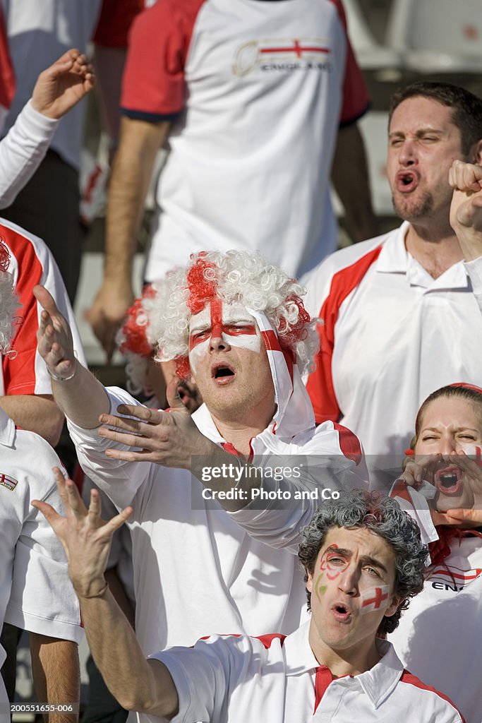 Rugby fans with English flag painted on face, booing