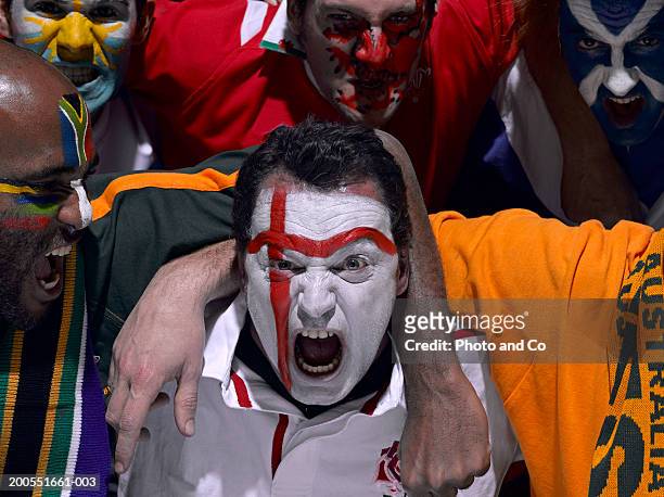 rugby fans with various country flags painted on face, shouting, portrait, close-up - rugby sport stock-fotos und bilder