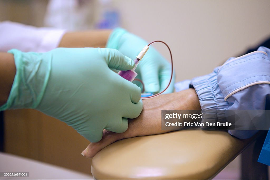 Doctor preparing intravenous injection for patient, close-up of hands