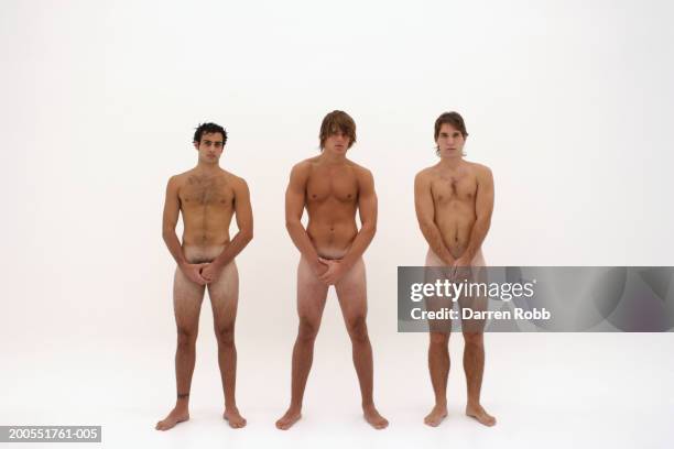 three naked young men standing in line, hands covering groin - nudity stock pictures, royalty-free photos & images