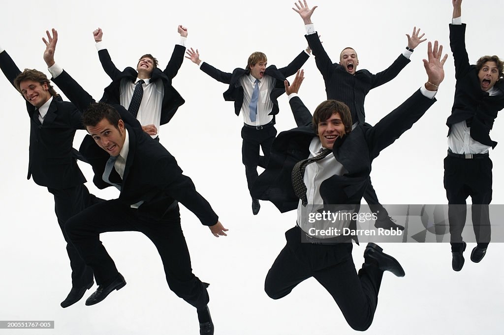 Group of young businessmen jumping in air, cheering