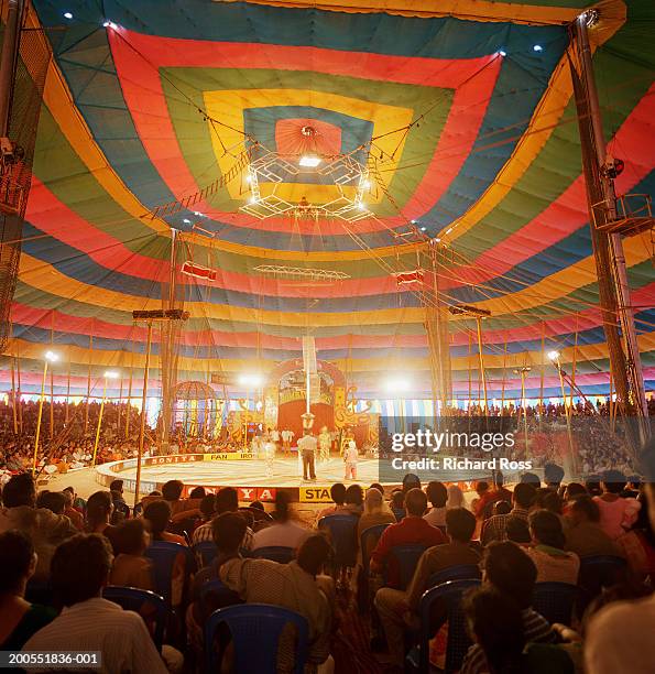 people watching circus in tent - carpa de circo fotografías e imágenes de stock