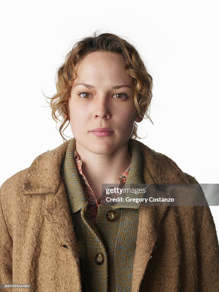 Young woman wearing overcoat, close-up, portrait