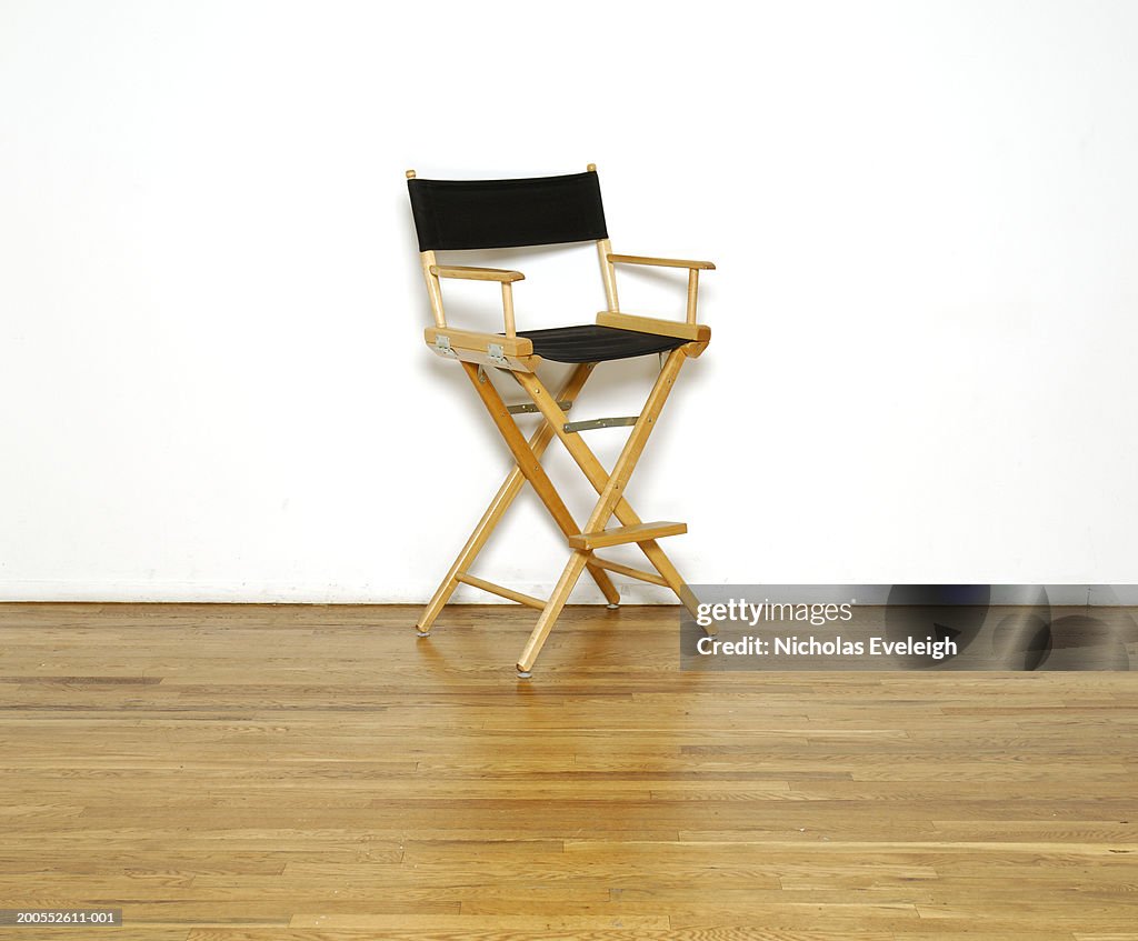 Director's chair on wooden floor, close-up