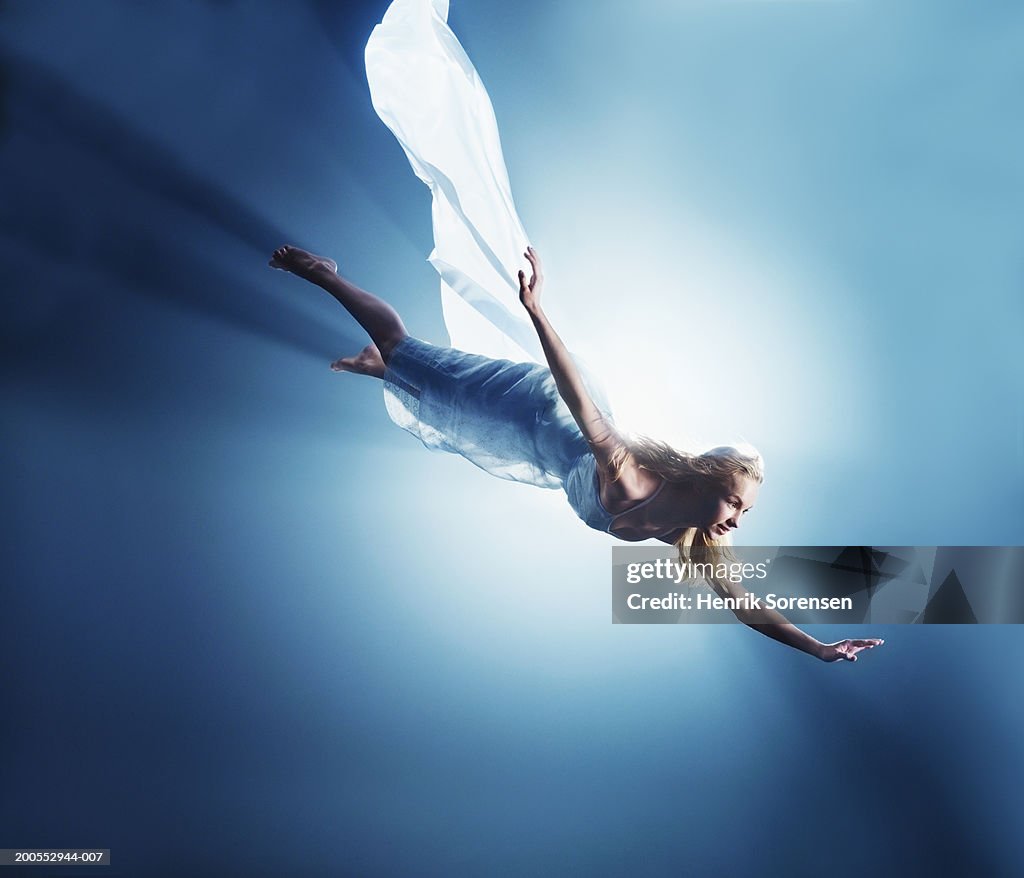 Young woman in air, low angle view